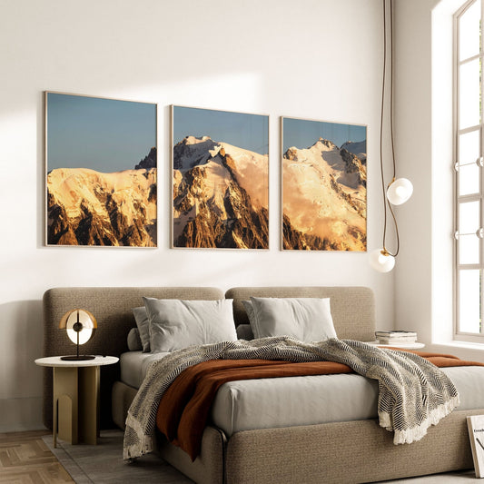 Three framed prints of Mont Blanc sunrise displayed above a modern bedroom setting, creating a serene and elegant ambiance.
