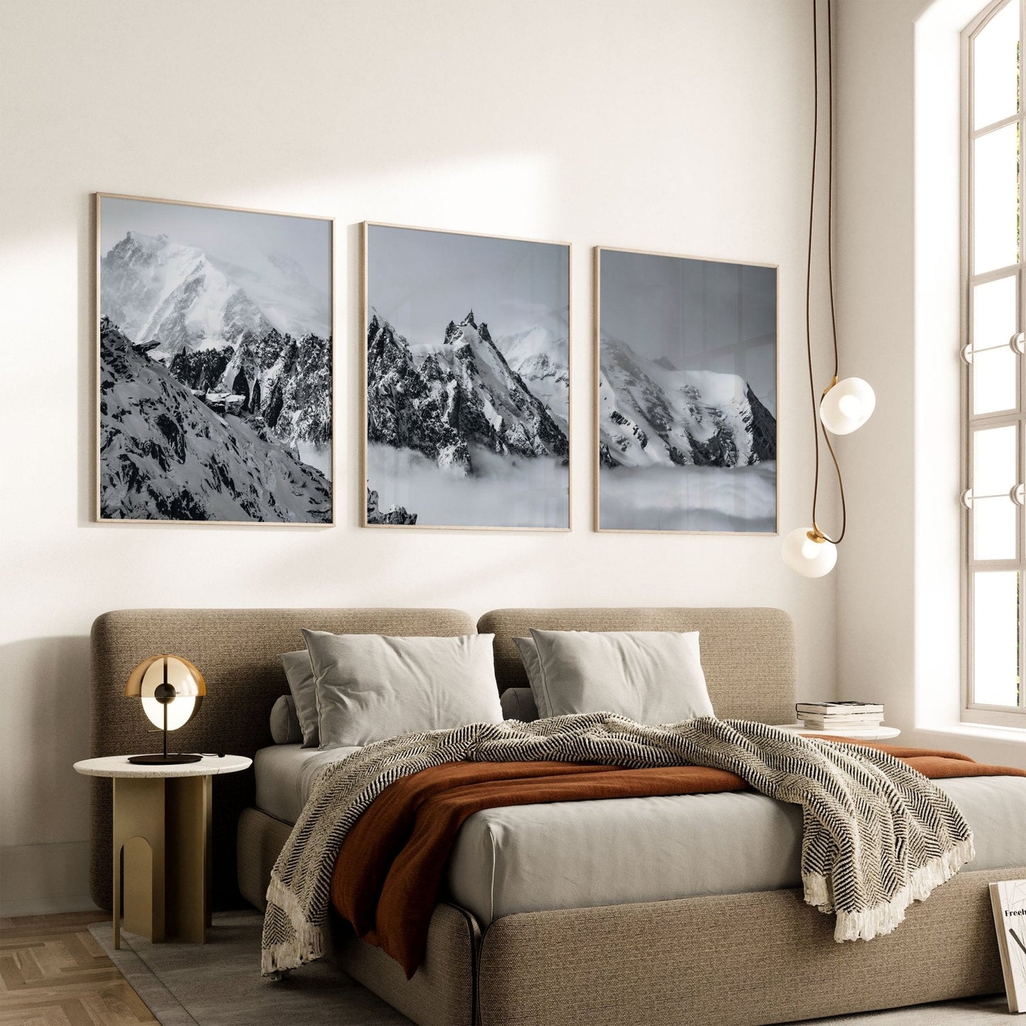 Mont Blanc triptych artwork displayed above a modern bedroom setup with neutral decor accents.