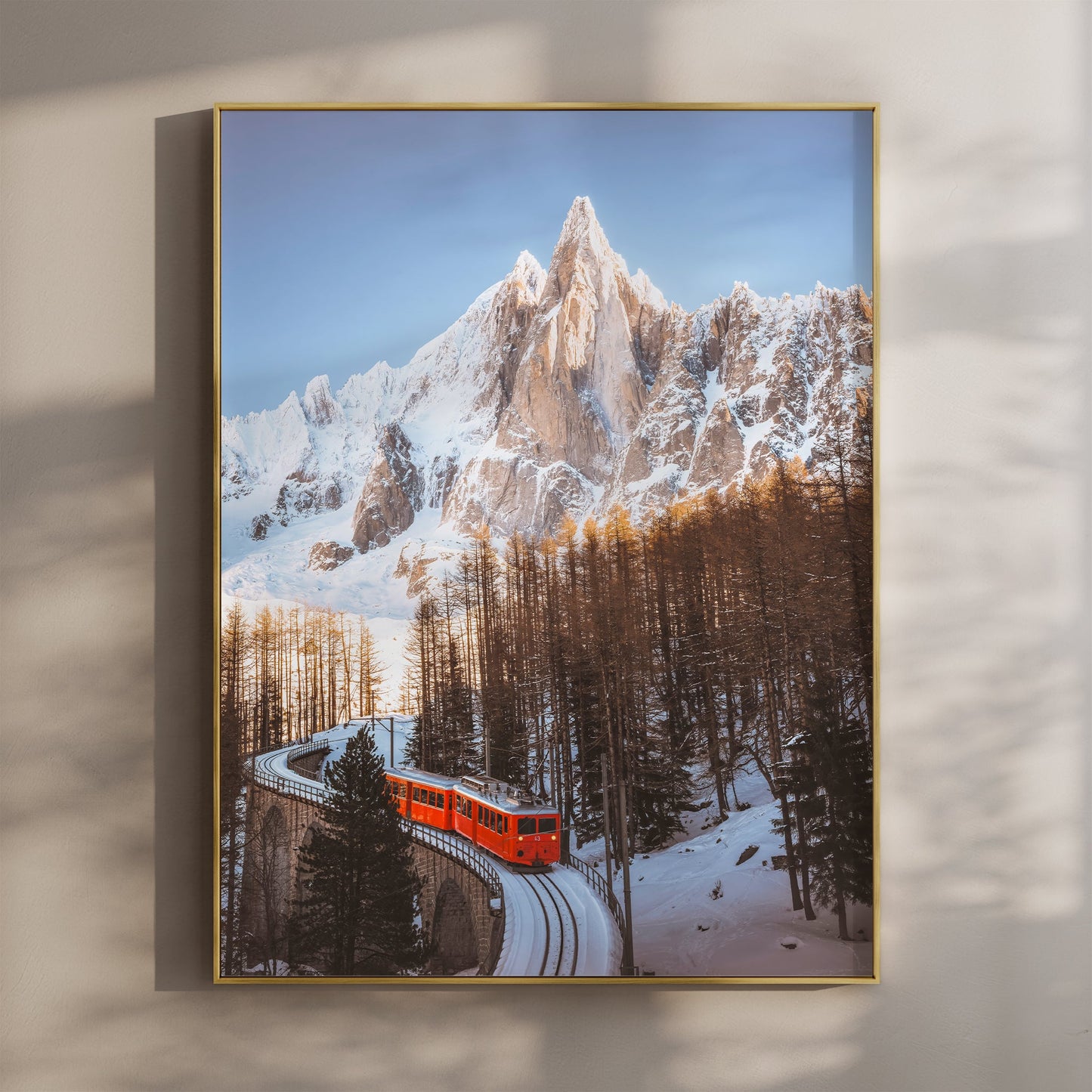 Stunning wall art featuring the iconic Montenvers Train winding through snowy alpine forests beneath the Aiguille du Dru.