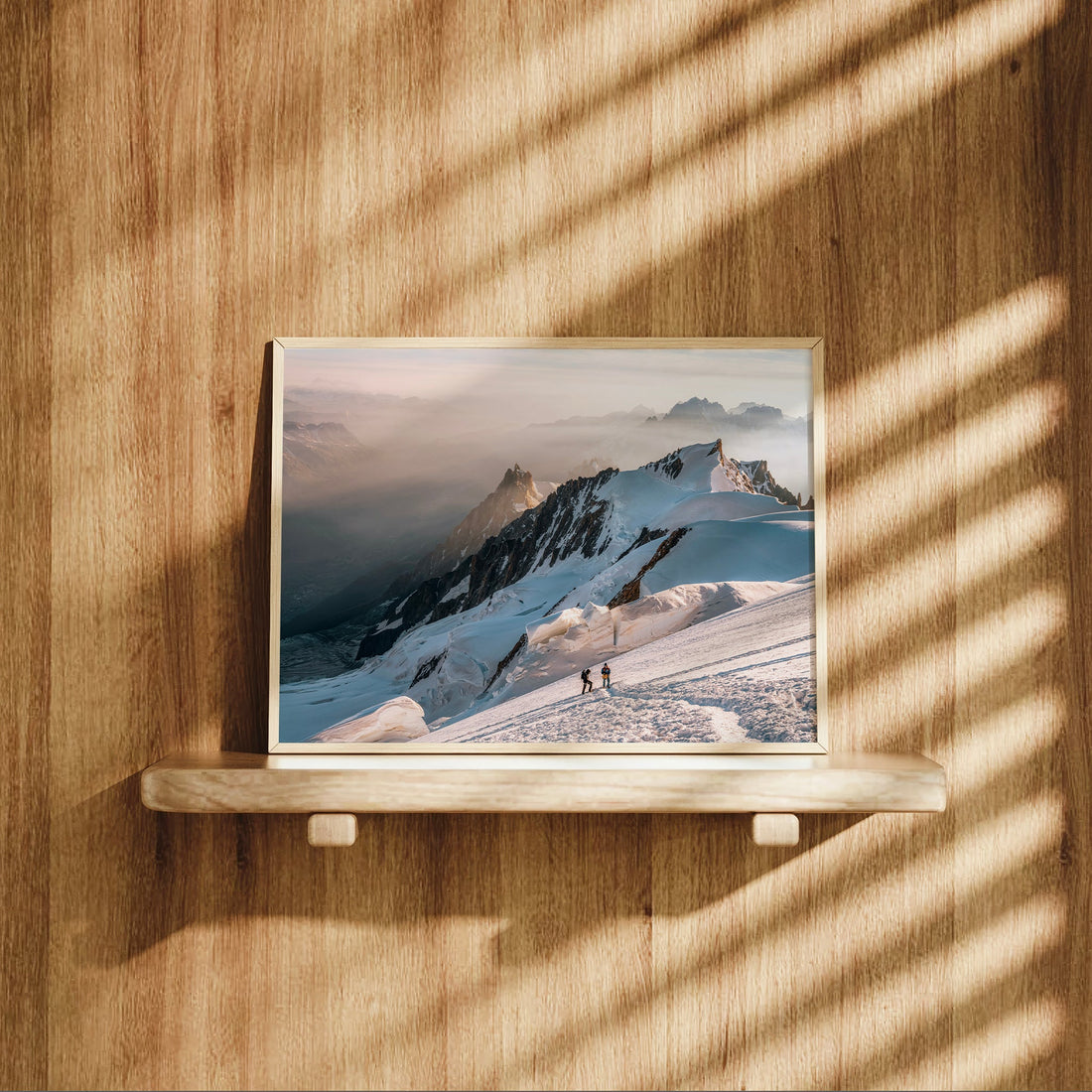 Stunning landscape print of mountaineers traversing icy slopes in the French Alps during early morning light.