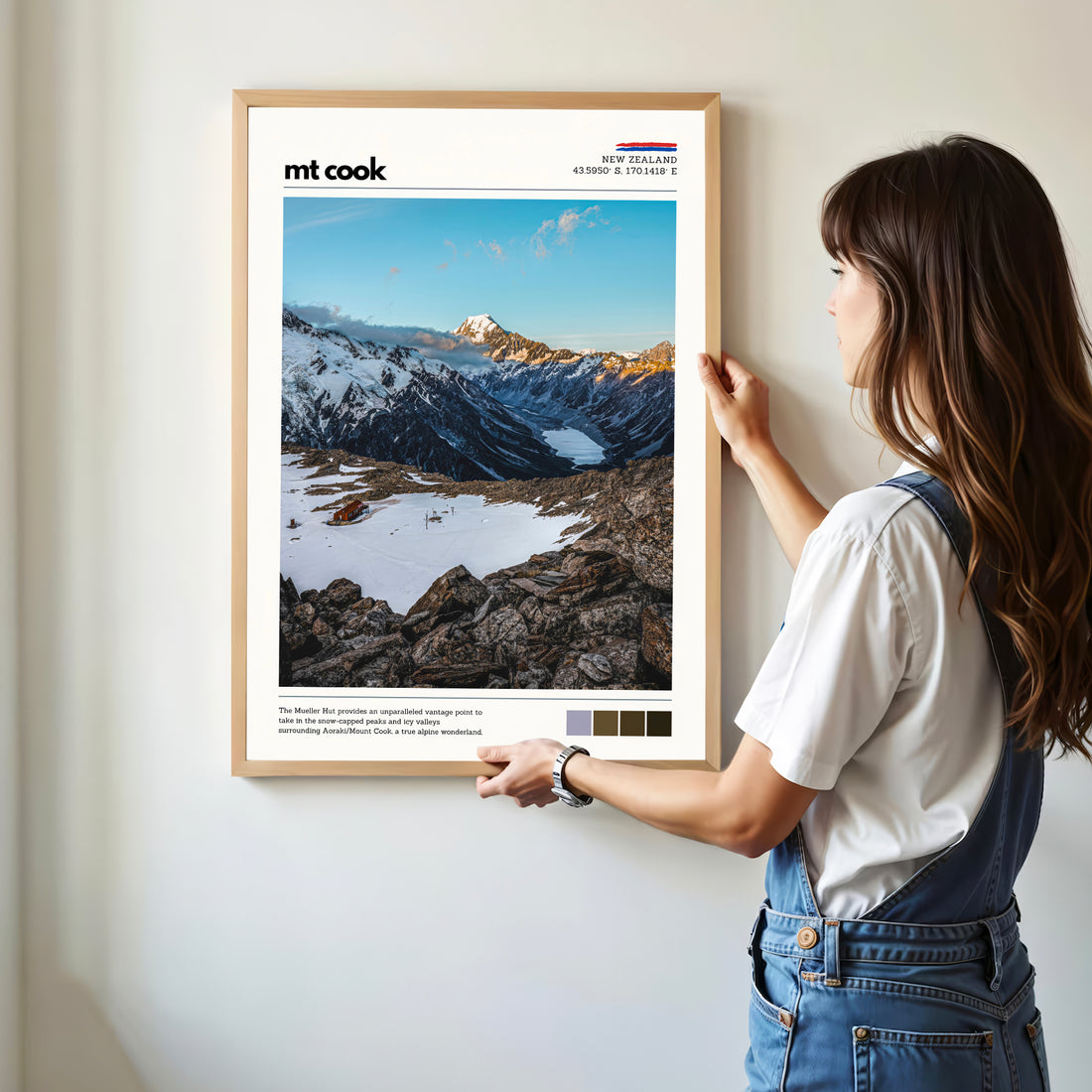 Person hanging a Mt Cook wall art print featuring the alpine scenery around Mueller Hut