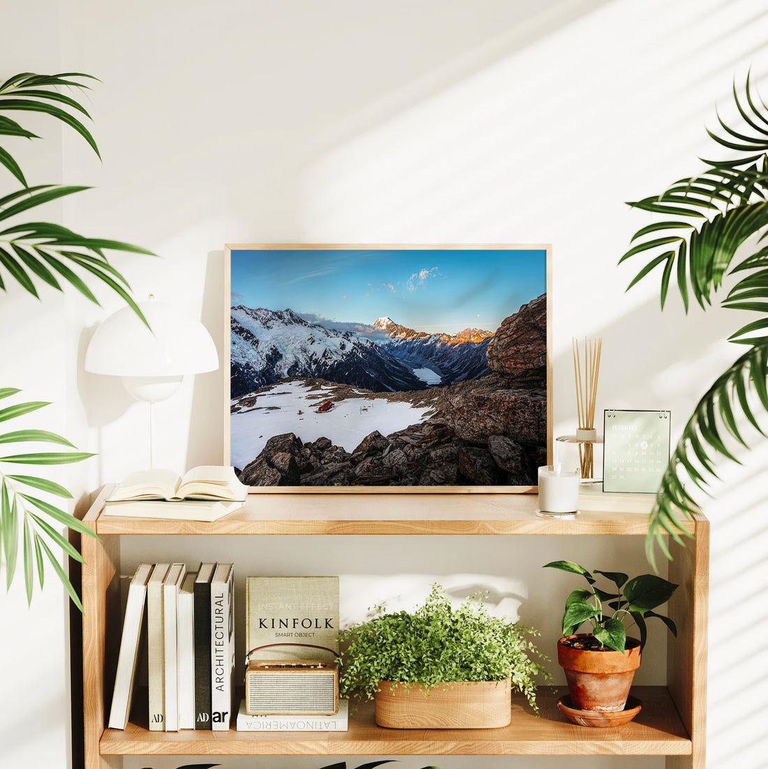 Mueller Hut Mount Cook National Park photography print in natural wood frame displayed on timber bookshelf in bright Scandi living room