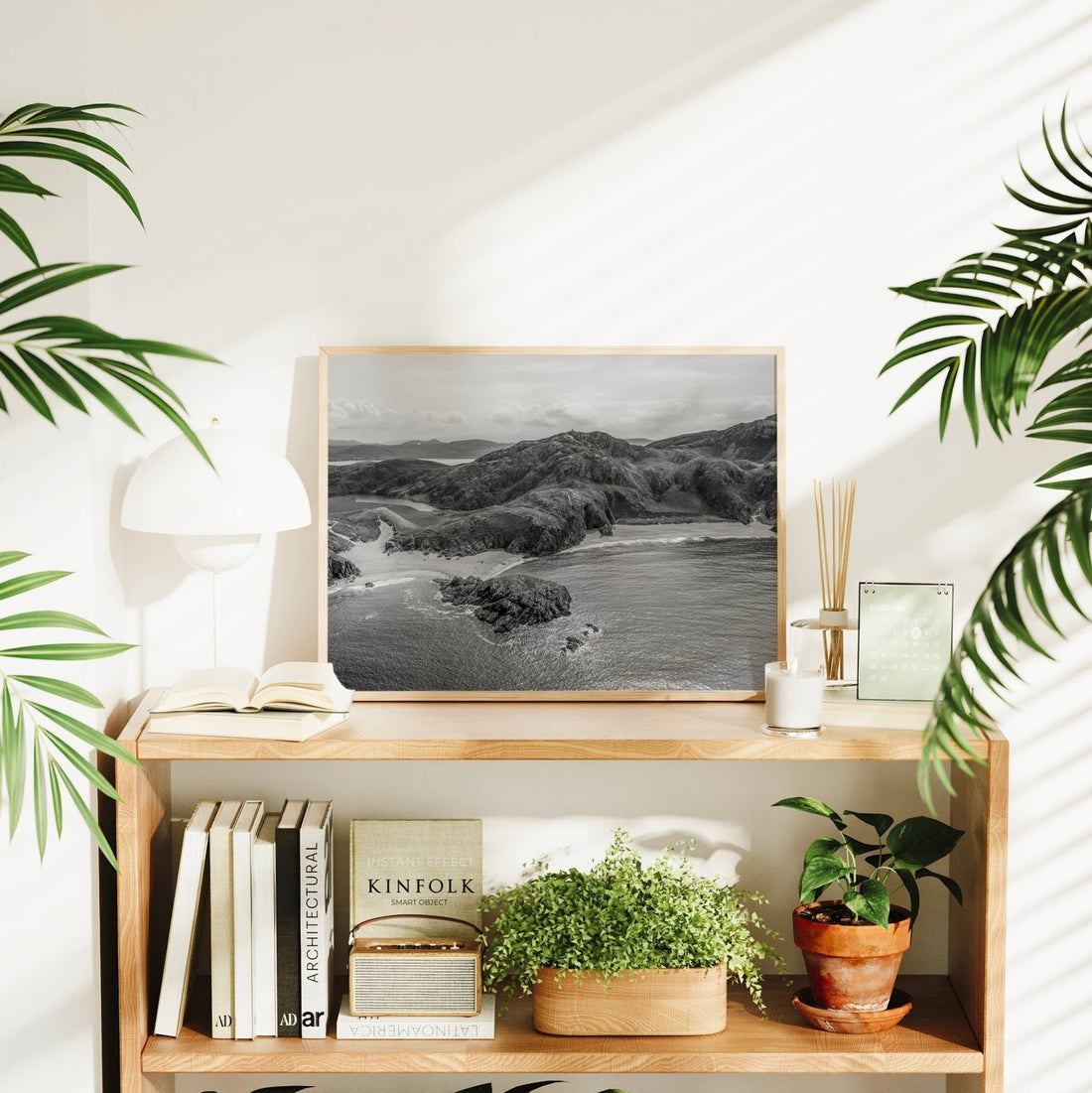 Irish coastal black and white photo print styled in a bright home with books and plants.