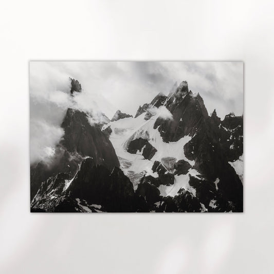 Fine art wall print of the iconic Needles of Chamonix in black and white with snowy glaciers and sharp rock spires.