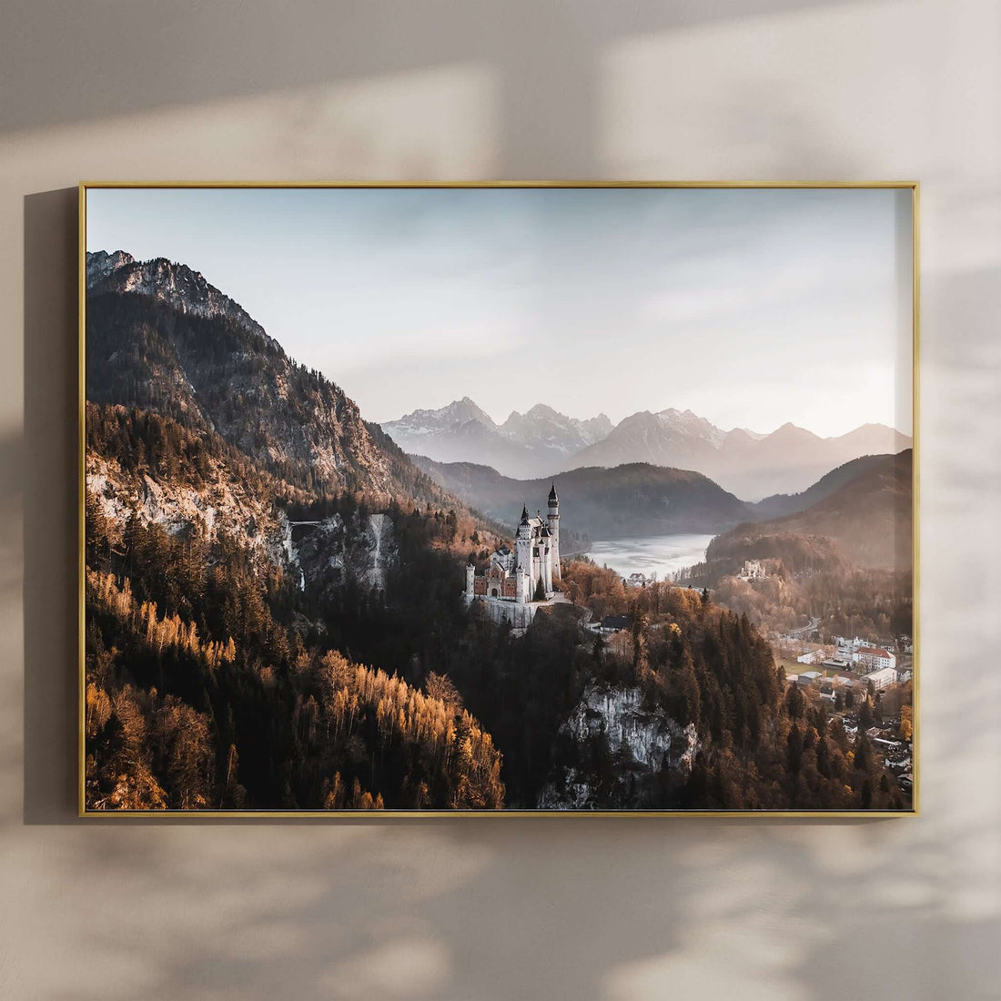 Aerial view of Neuschwanstein Castle with mountains in the background at golden hour