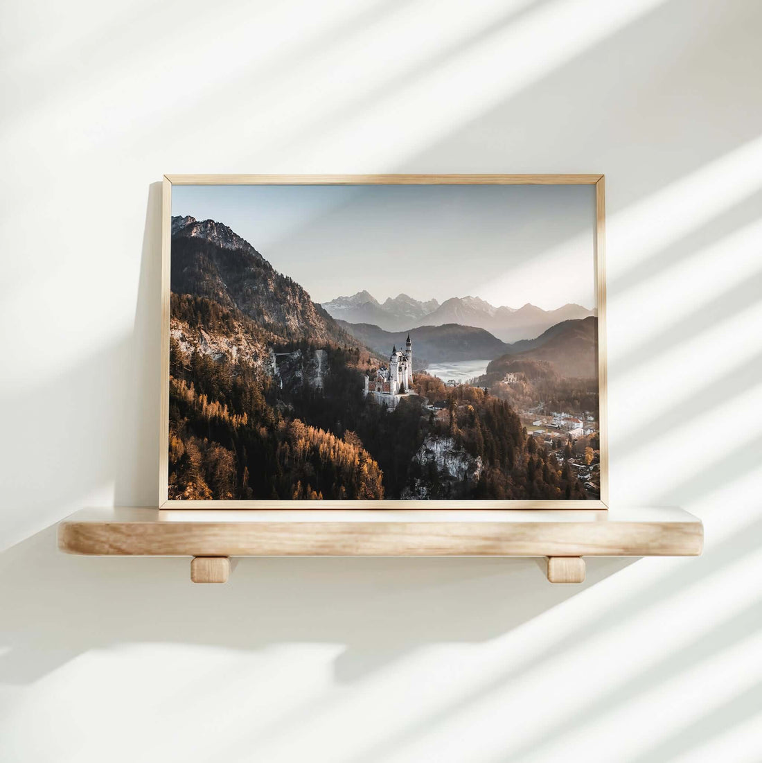 Photography print of Neuschwanstein Castle with early morning mist and mountain peaks