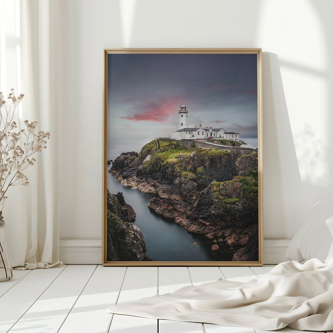 Framed Irish lighthouse print in a bright minimalist room