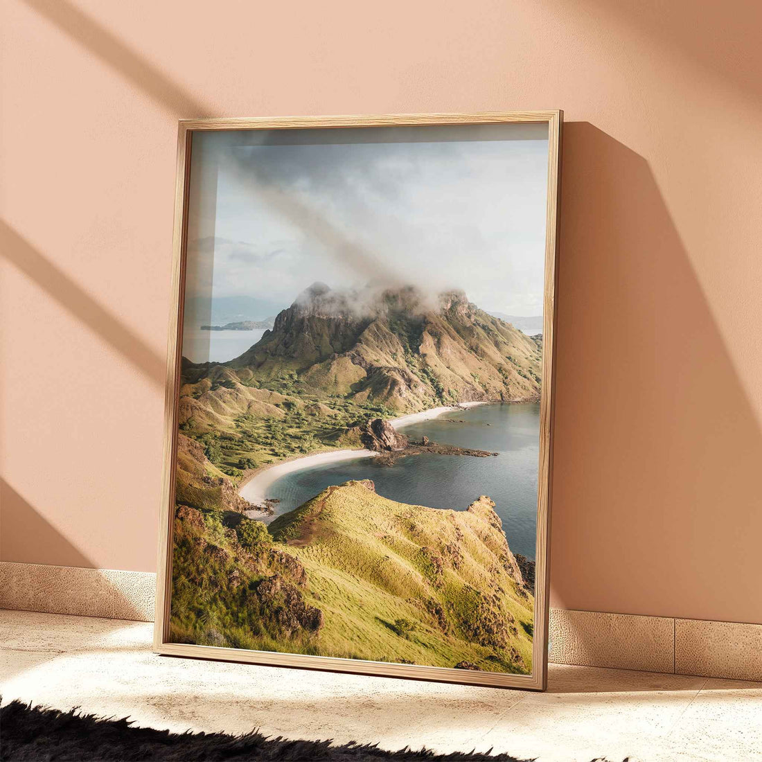 Padar Island Komodo National Park travel print in natural wood frame leaning against peach terracotta wall