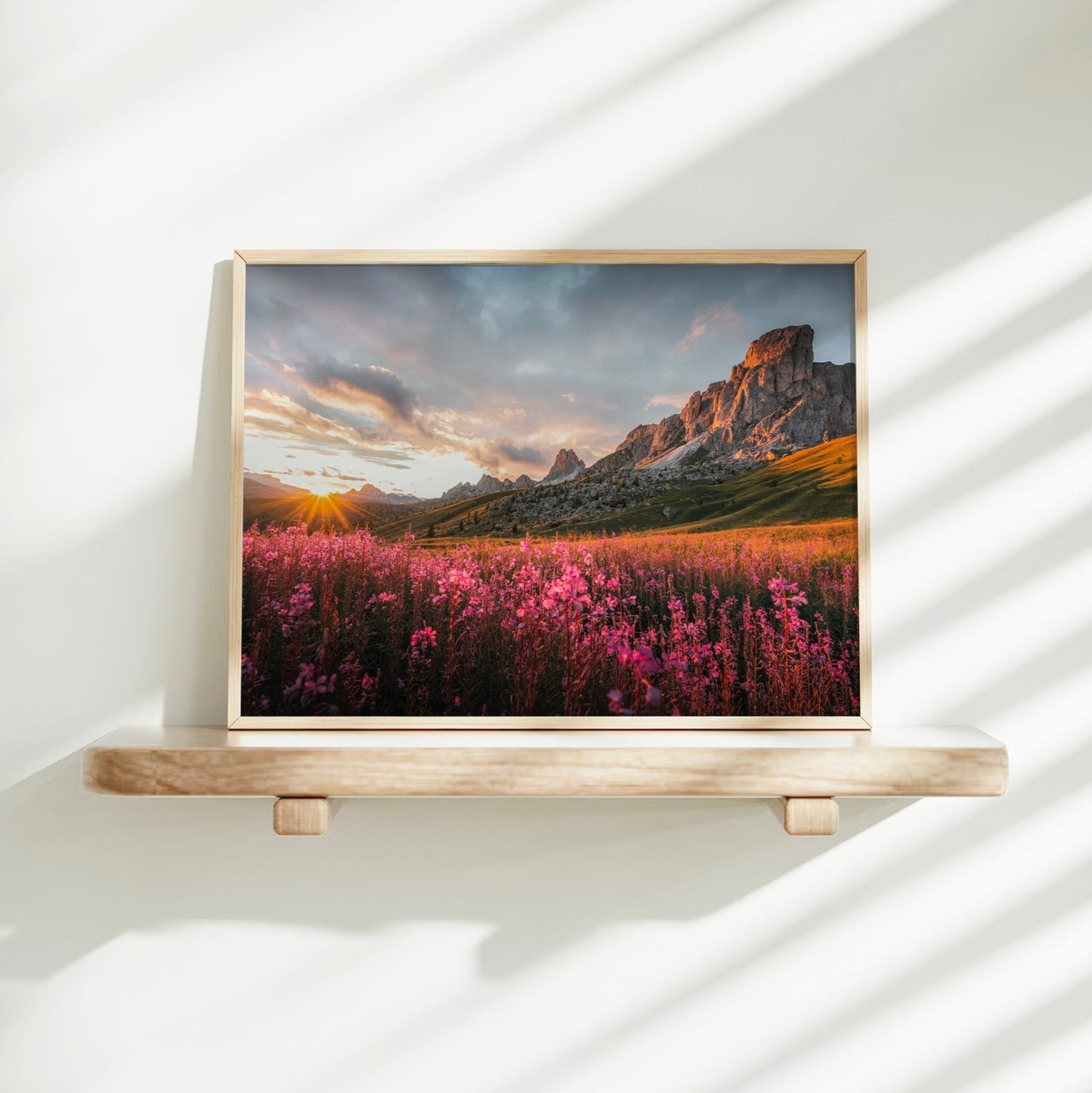 Stunning sunrise print of Passo Giau with morning sun rays lighting up the wildflower-strewn valley.