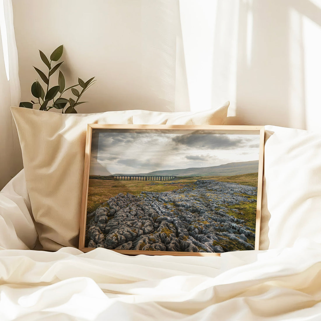 Ribblehead print on bed with soft linens and natural window light