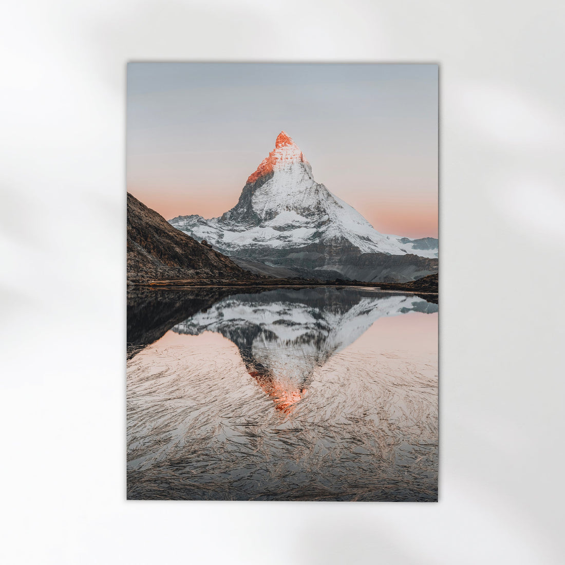 Breathtaking fine art print of Riffelsee, a tranquil alpine lake reflecting the majestic Matterhorn at dawn.