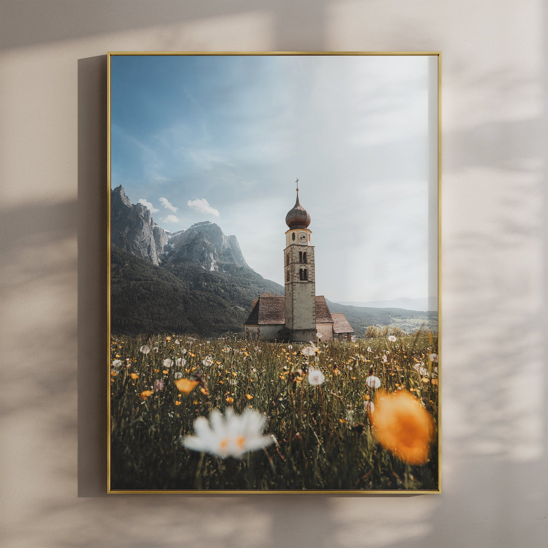 San Valentino church in the Dolomites surrounded by wildflowers and dramatic mountains