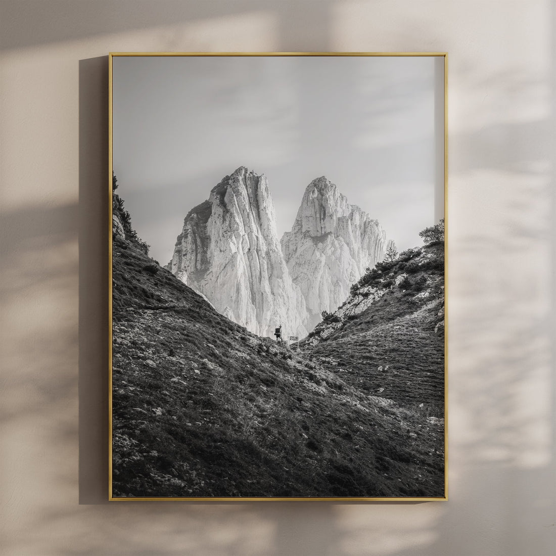 Framed black and white print of Saxer Lücke mountain peaks with hiker in living room wall display