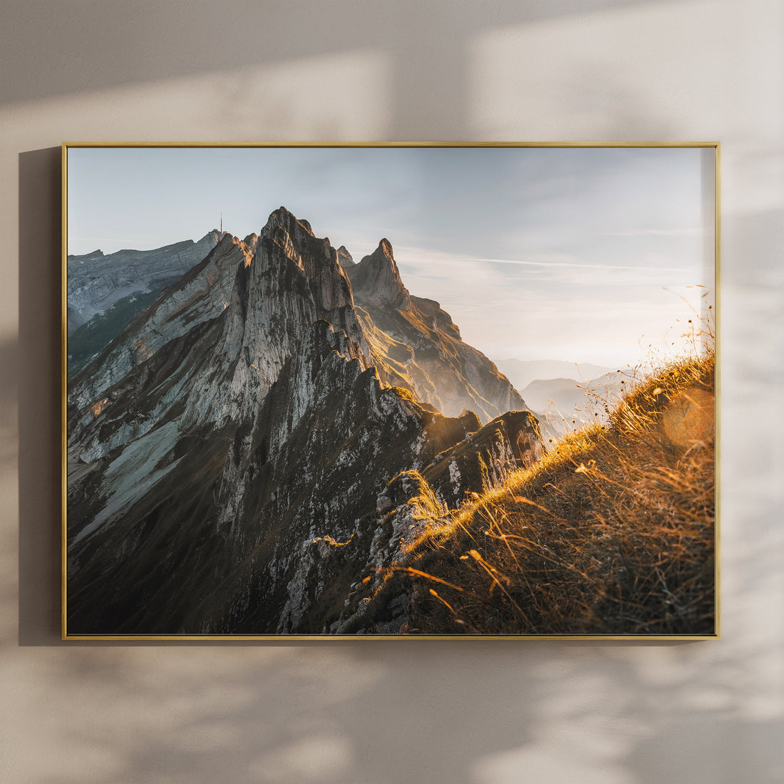 Schäfler Ridge wall art print featuring dramatic cliffs and golden alpine grass in soft morning light.
