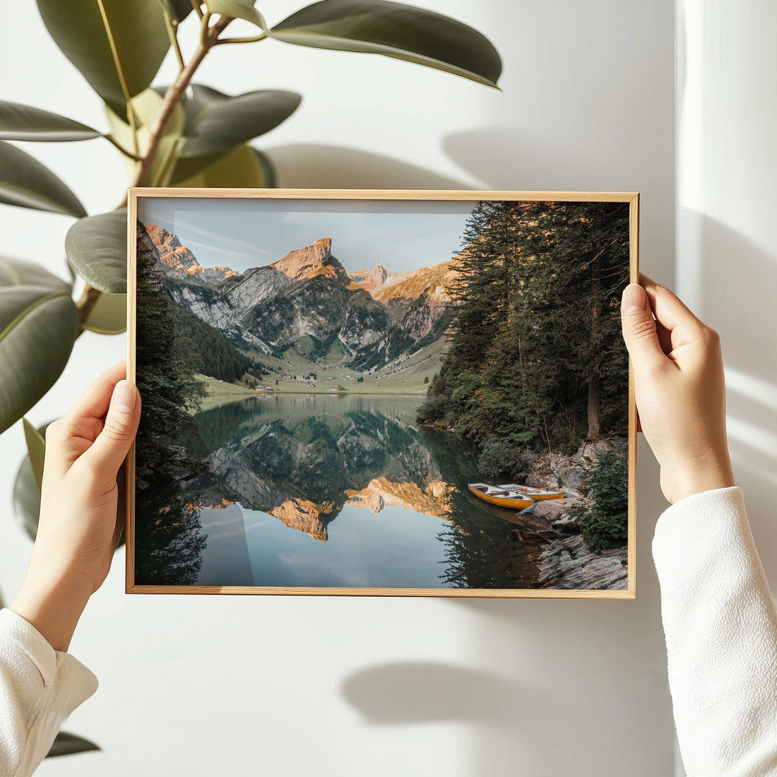 Peaceful alpine photography print showing a yellow boat resting on Seealpsee's shore with mountain reflections.