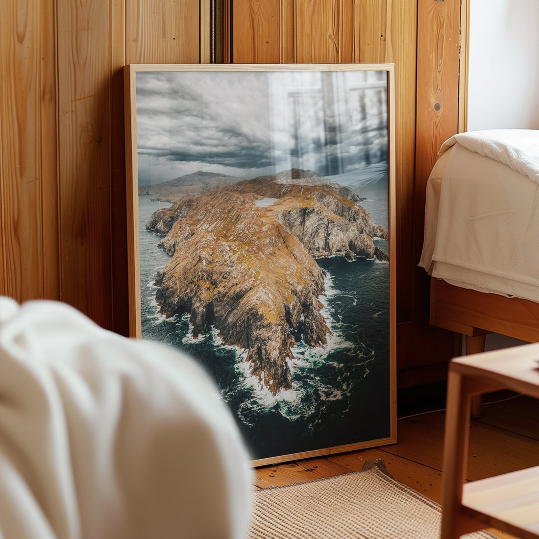 Framed Irish coastal wall art print of Sheep’s Head Peninsula leaning on bedroom wall.