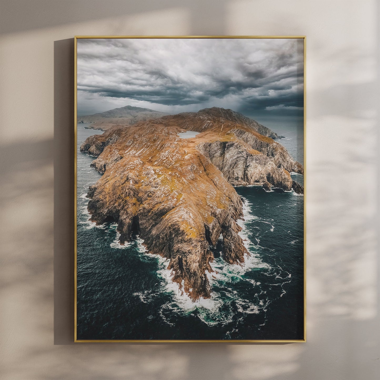 Aerial view of Sheep’s Head Peninsula with dramatic clouds and golden cliffs.