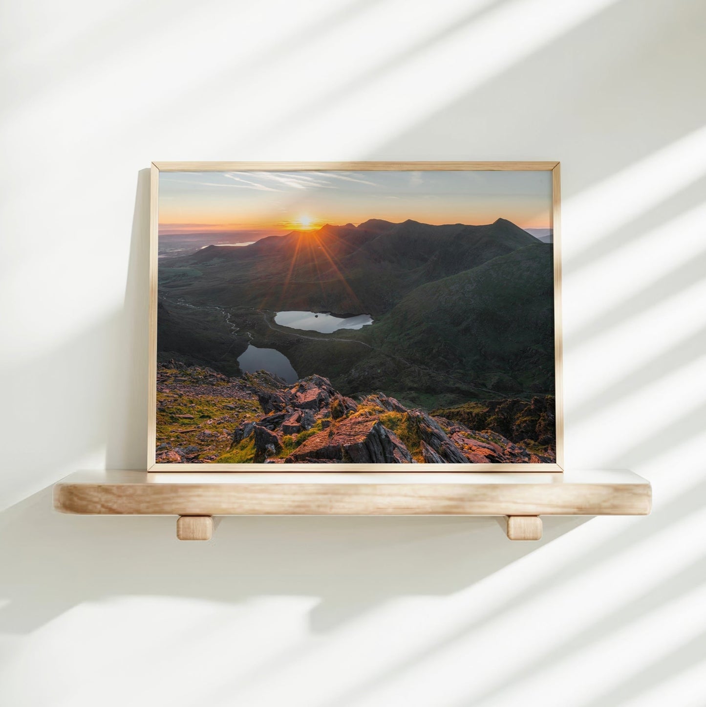 Minimal shelf display with golden sunlight hitting Carrauntoohil print.