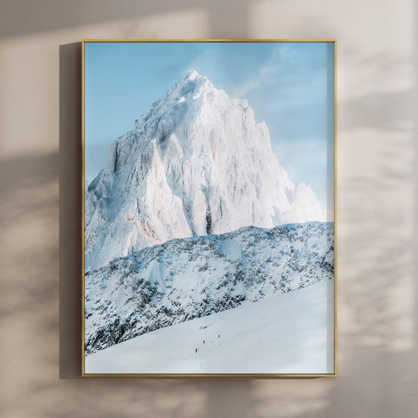 Ski tourers traverse the snowy slopes of Mont Blanc near Chamonix, surrounded by breathtaking alpine peaks.