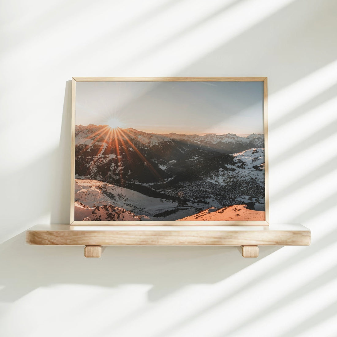 Serene snow-covered Verbier scene with early morning sunlight spilling across the mountains and valley.