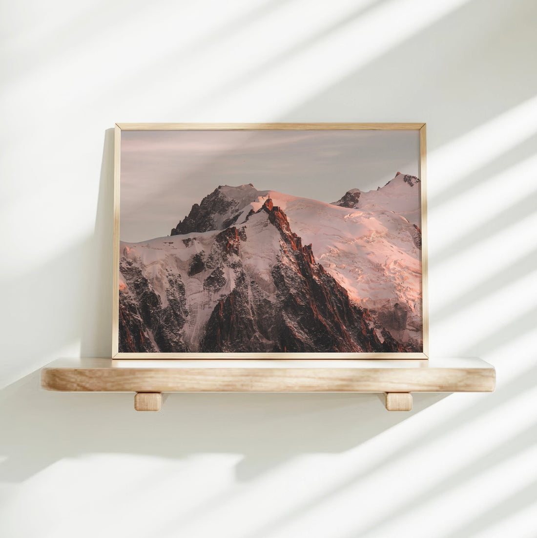 Photography print of snowy alpine peaks at dusk with soft pink tones, captured near Mont Blanc in France.