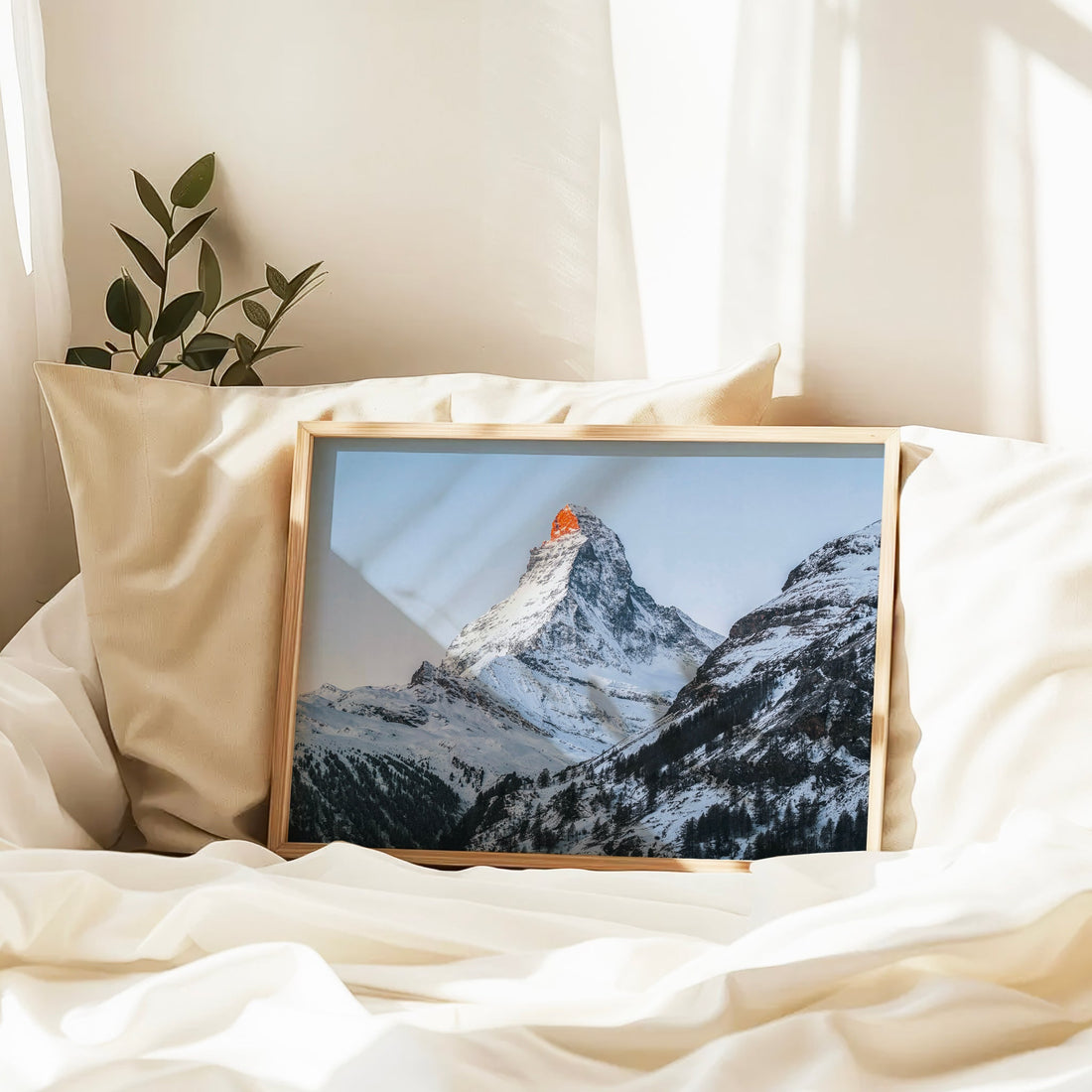 Snowy Matterhorn Zermatt print framed in natural wood, ideal for cozy mountain-inspired home decor.