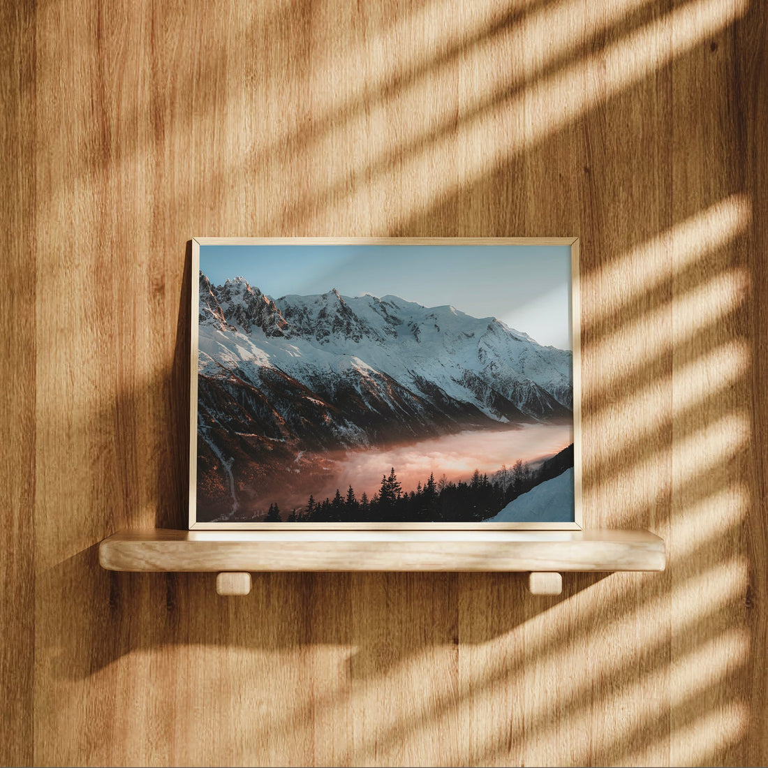 Photography print of snow-covered Mont Blanc slopes glowing at sunset with silhouetted alpine forest below.