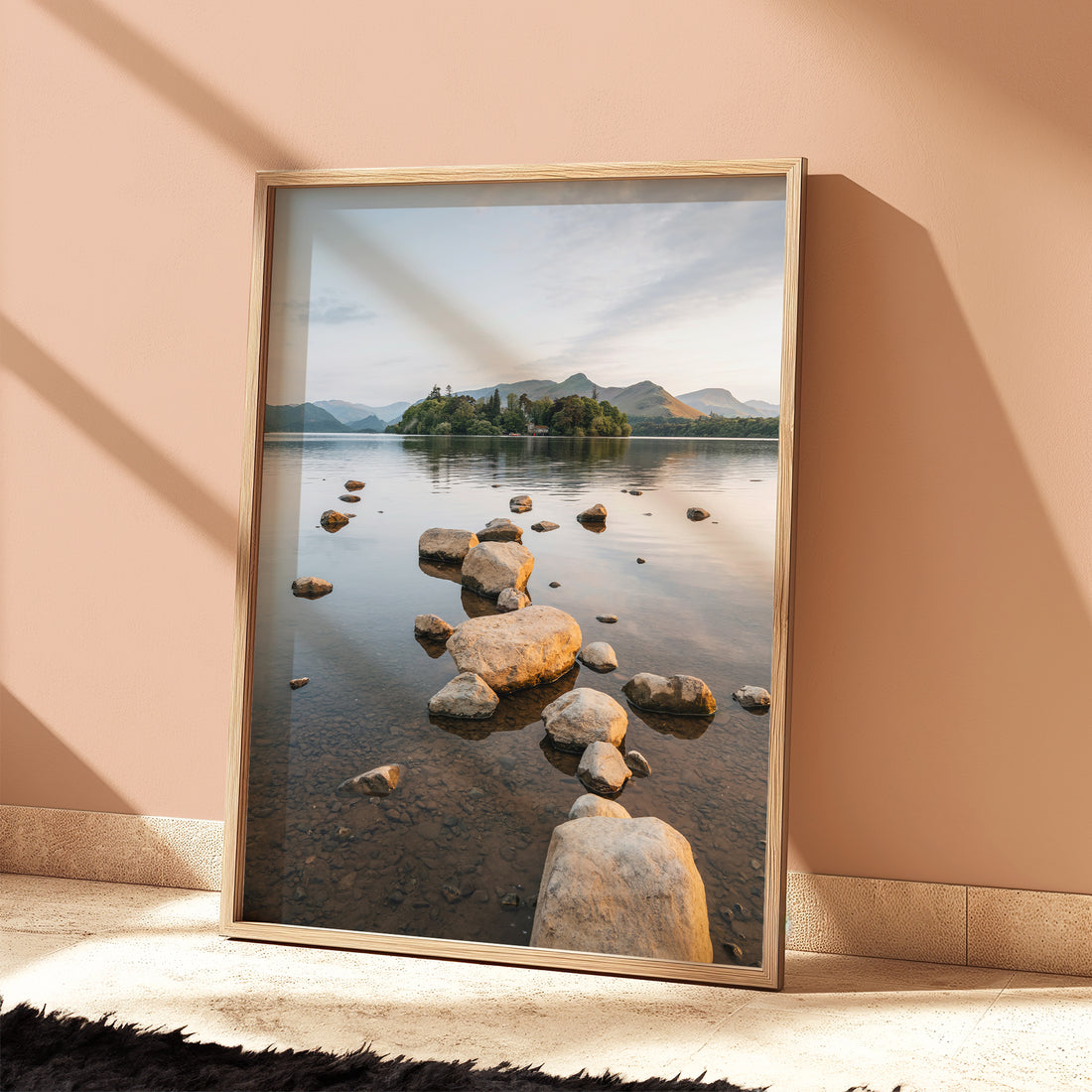 Derwentwater landscape print displayed in a bright room with sunlit shadows and soft colours
