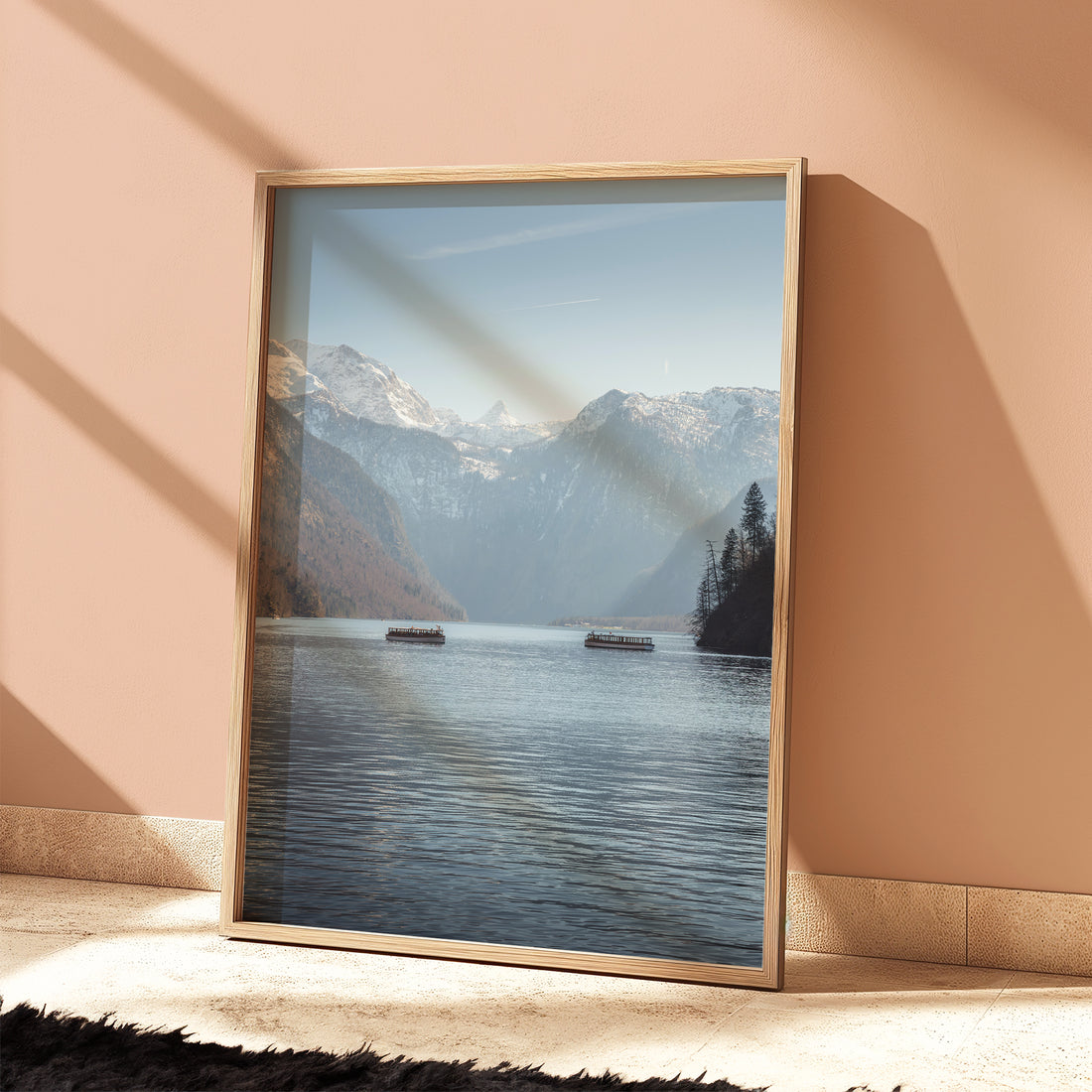 Framed Konigssee artwork leaning on a peach-coloured wall in sunlight
