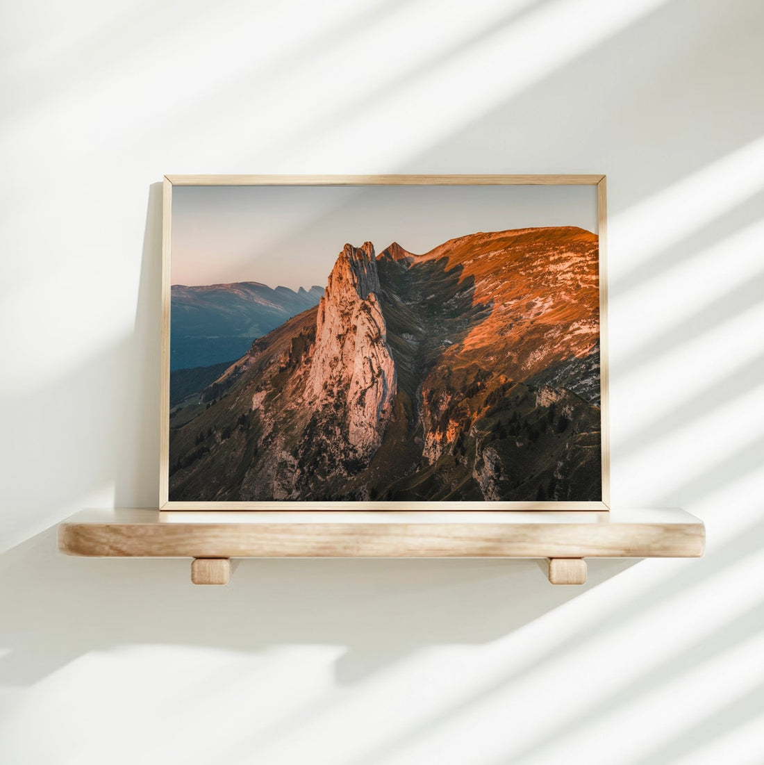 Sunrise landscape photo featuring the Saxer Lücke ridge glowing orange above shadowed valleys.