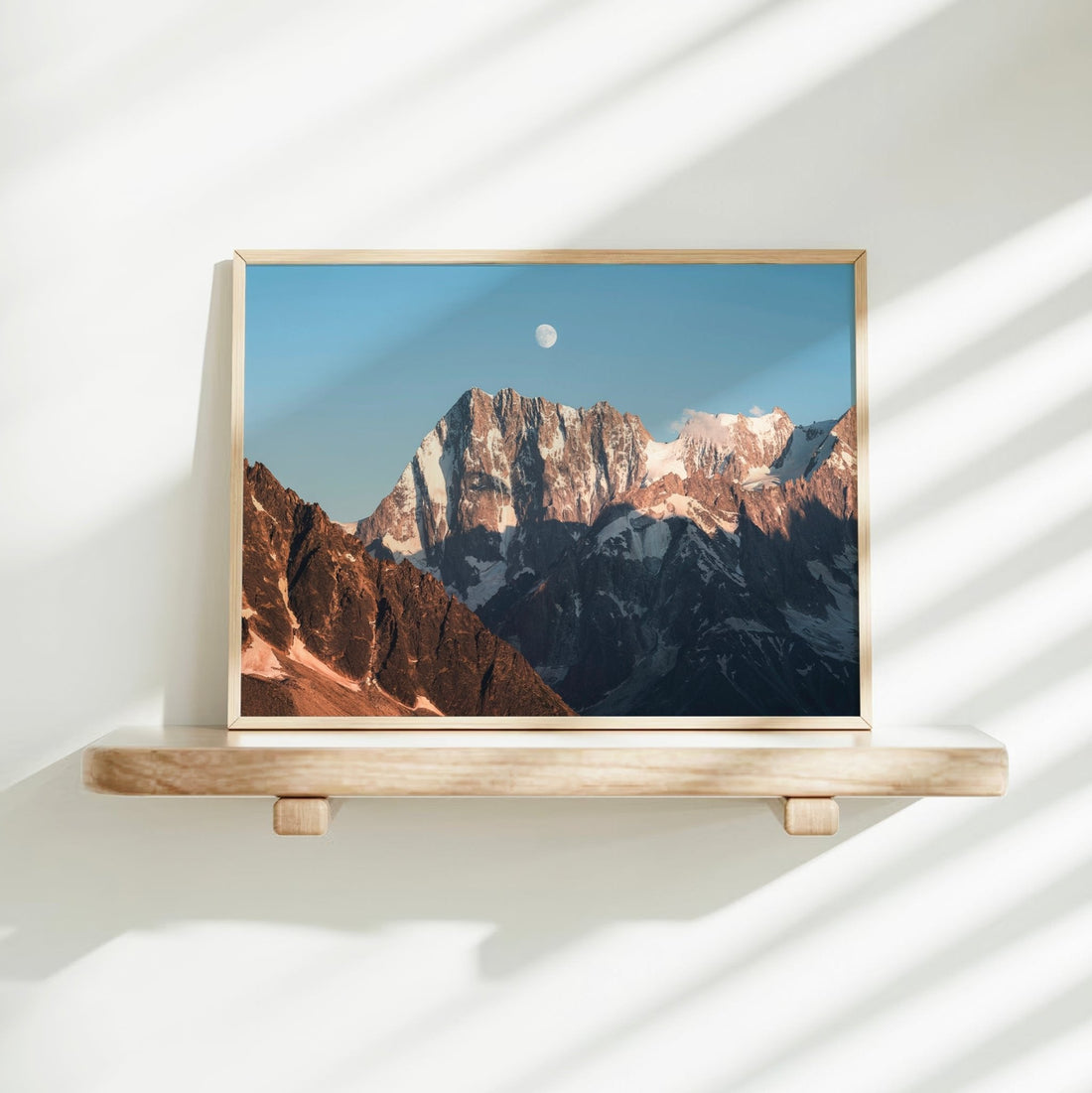 A striking alpine wall art print of Grandes Jorasses at sunset with full moon and deep shadows in the Alps.