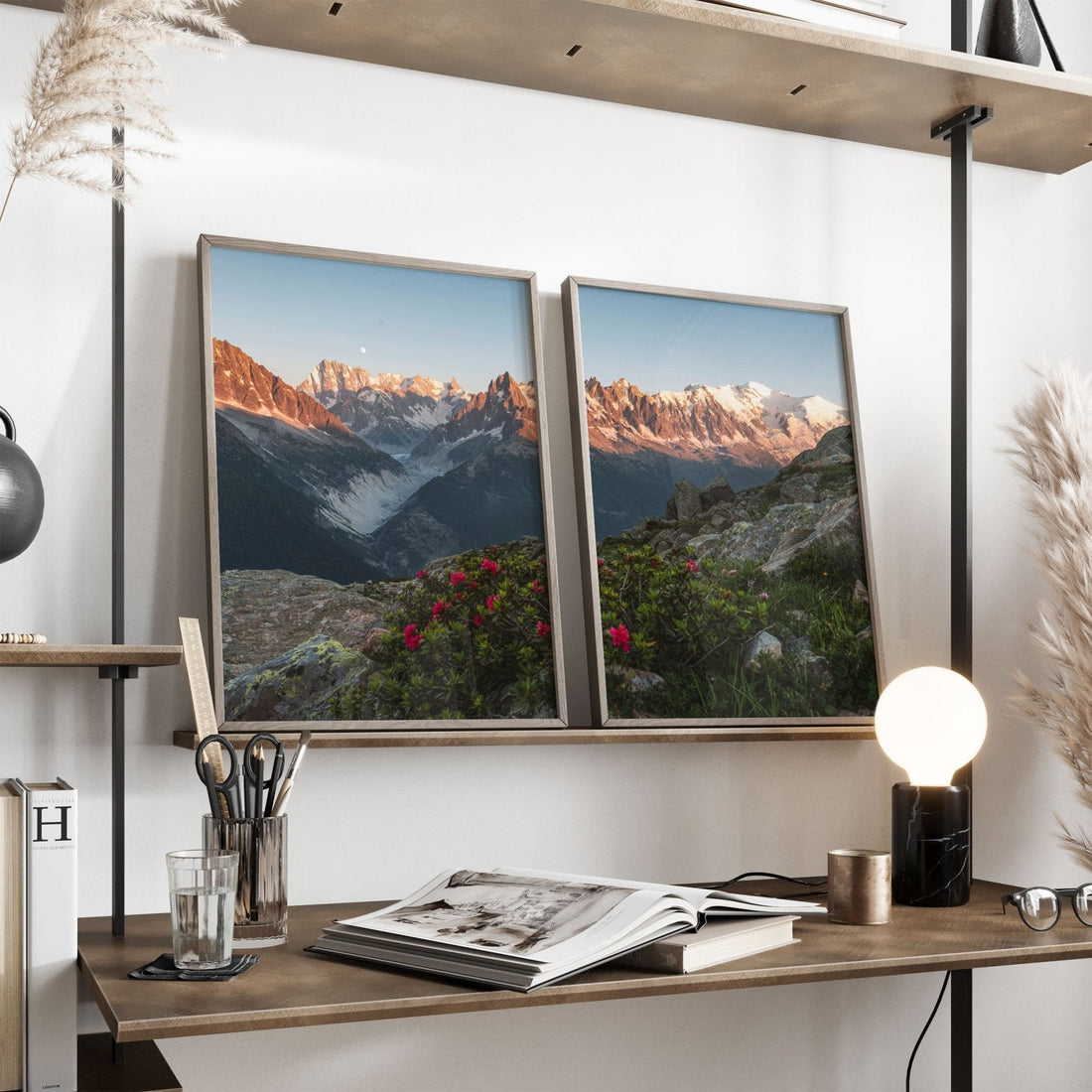 Interior decor with a shelf holding framed prints of sunset-lit mountain peaks, enhanced by vibrant wildflowers.