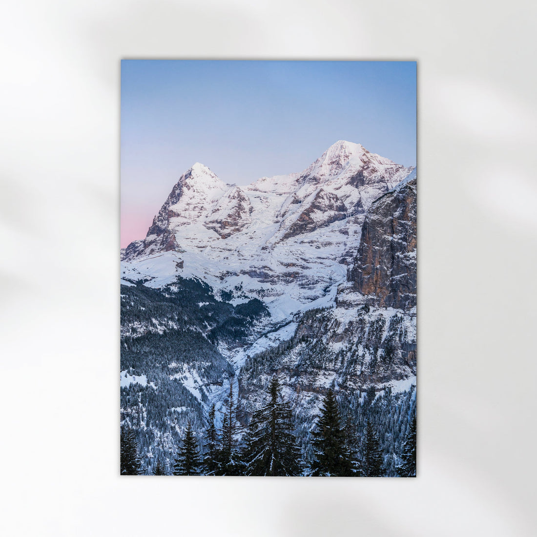 Stunning Swiss Alps photography print featuring the iconic Eiger mountain under a pastel sky at dusk.