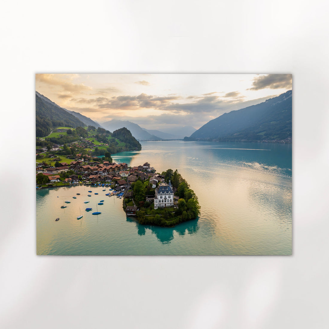 Scenic aerial photography of Iseltwald village on Lake Brienz, nestled in the Swiss Alps with stunning mountain reflections.