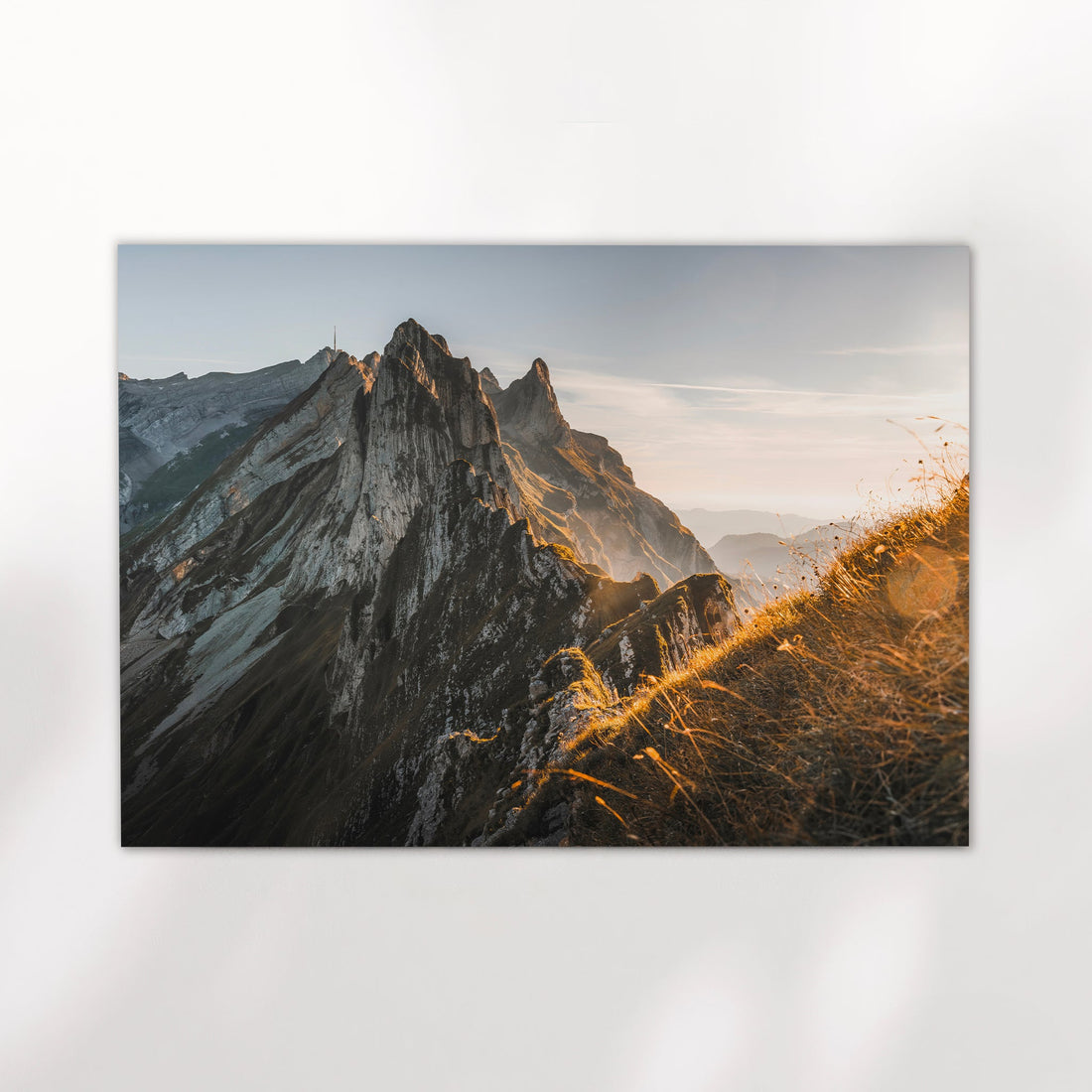 Sunrise photo print of Schäfler Ridge in the Appenzell Alps, bathed in golden glow and layered mountain haze.