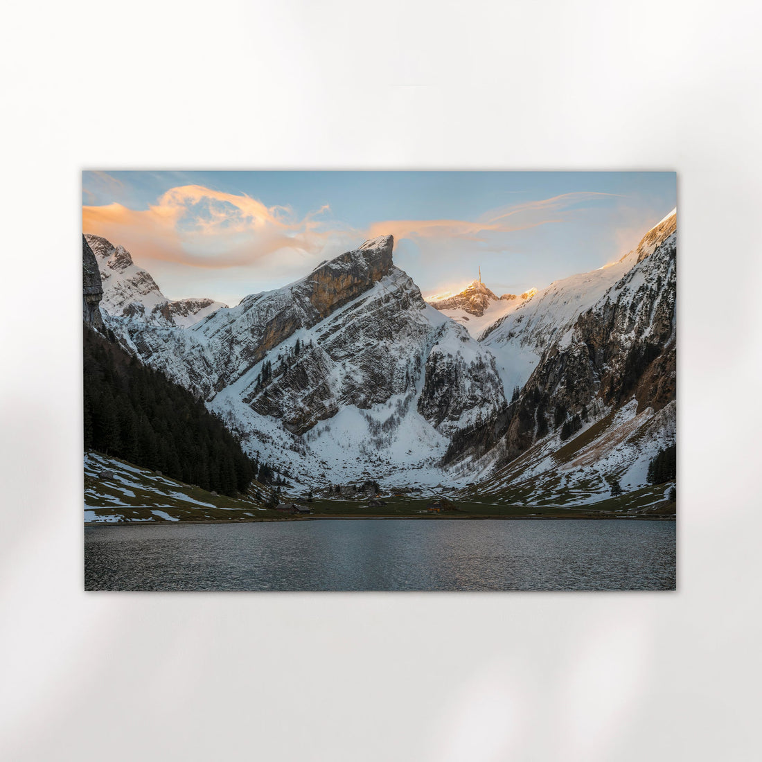 Breathtaking Swiss Alps photography print of Seealpsee in winter, with soft clouds above icy peaks.