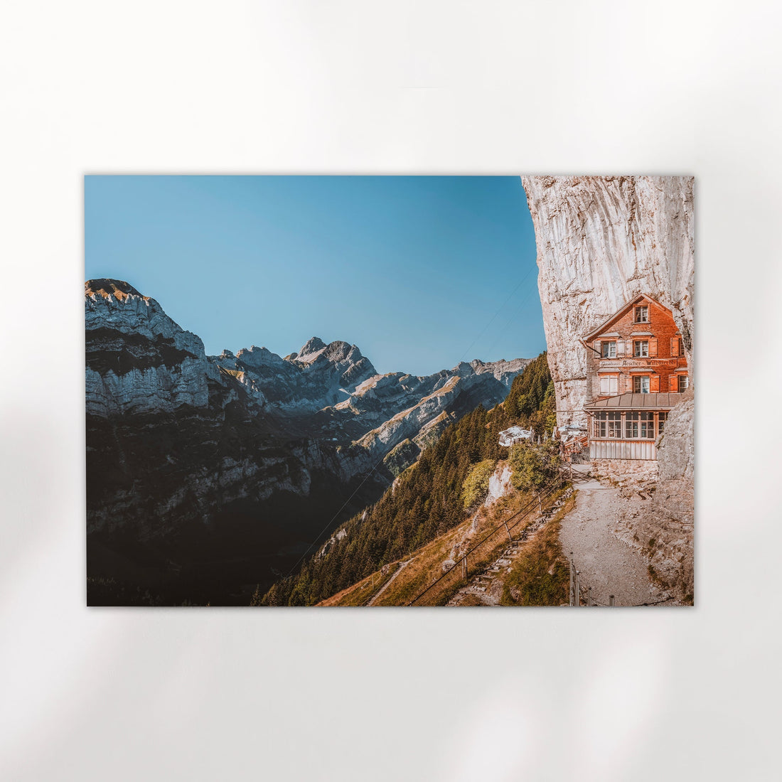 Scenic Swiss mountain inn landscape photo showcasing Aescher Guesthouse against a dramatic alpine backdrop.