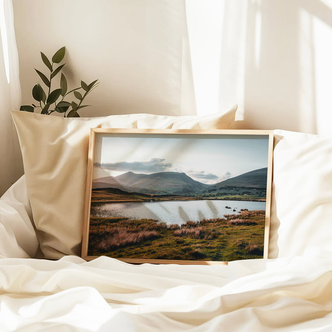 Cumbrian mountains and Tewet Tarn landscape print framed on bed