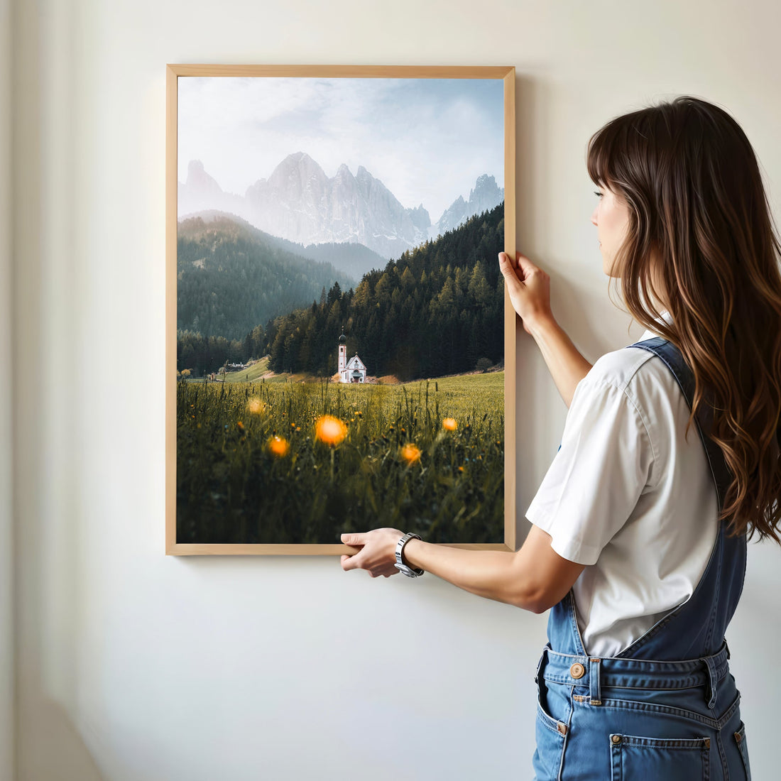 Woman holding print of St. John’s Church in Val di Funes, Dolomites landscape
