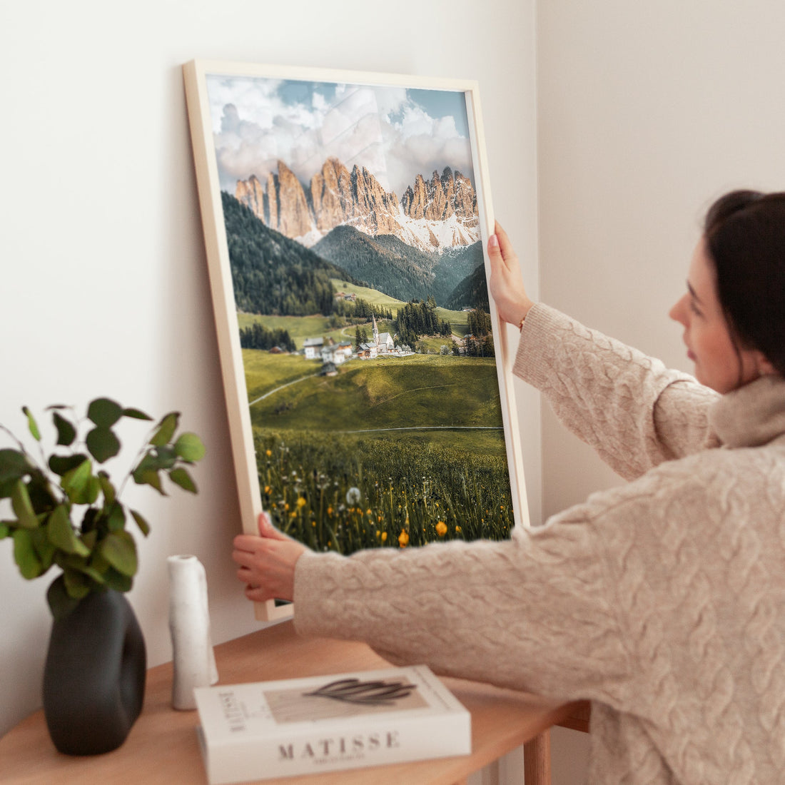 Woman styling Val di Funes sunset photography print in modern home