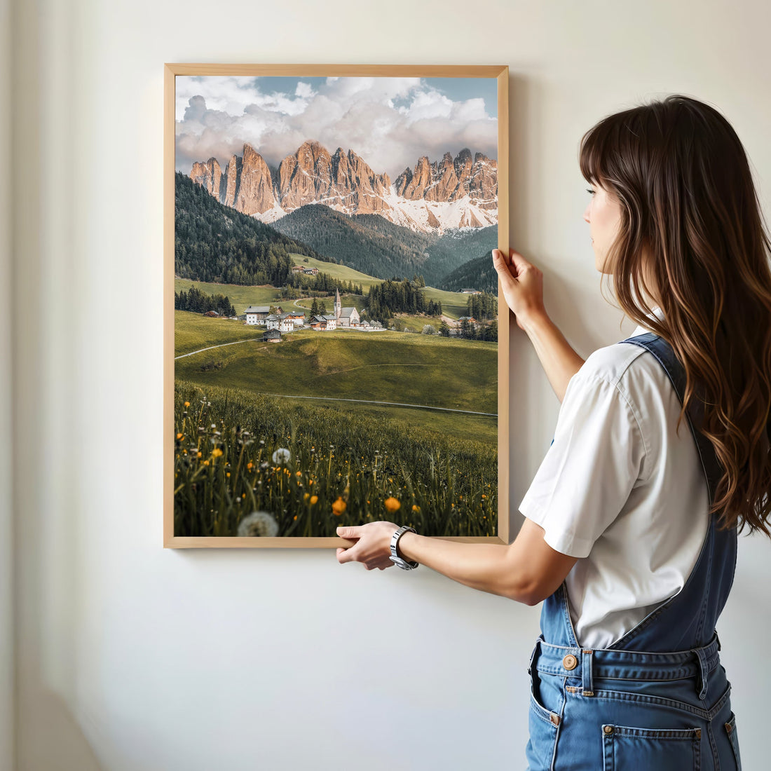 Person holding Val di Funes Dolomites photo print in a minimal home