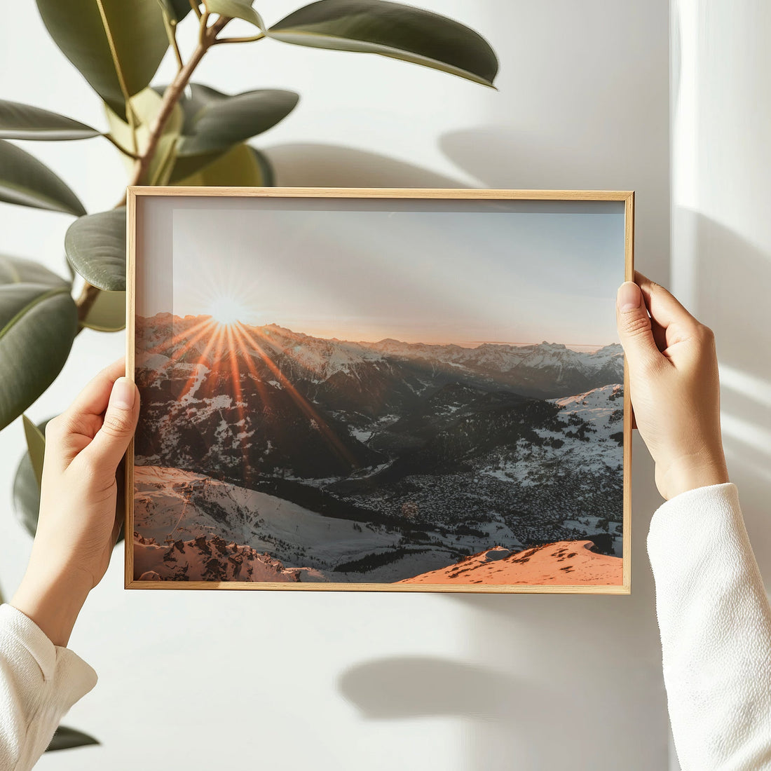 Aerial fine art photo of Verbier ski resort and alpine terrain under soft orange sunrise light.