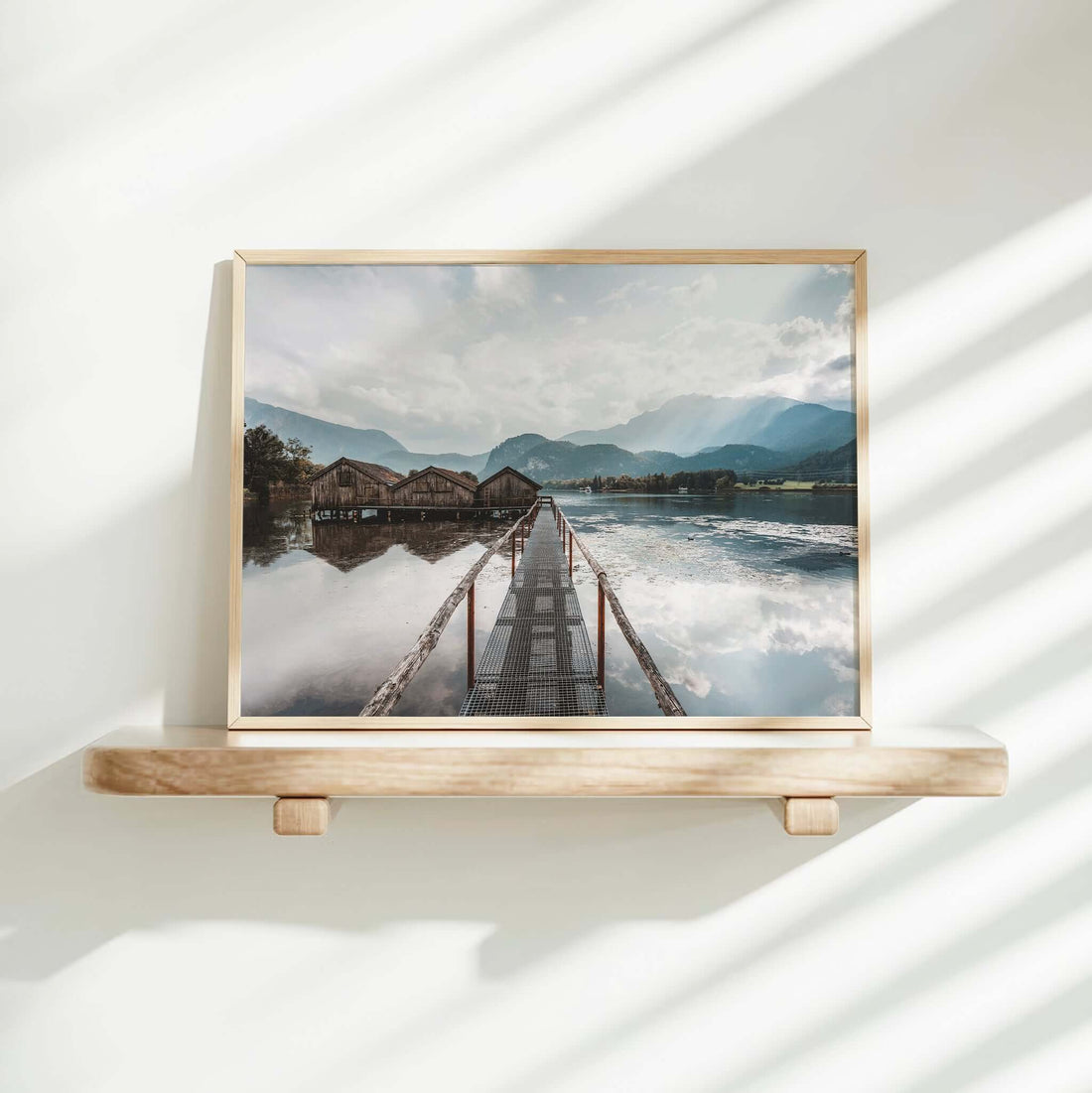 Woman decorating home with Kochelsee lake and boathouses landscape print