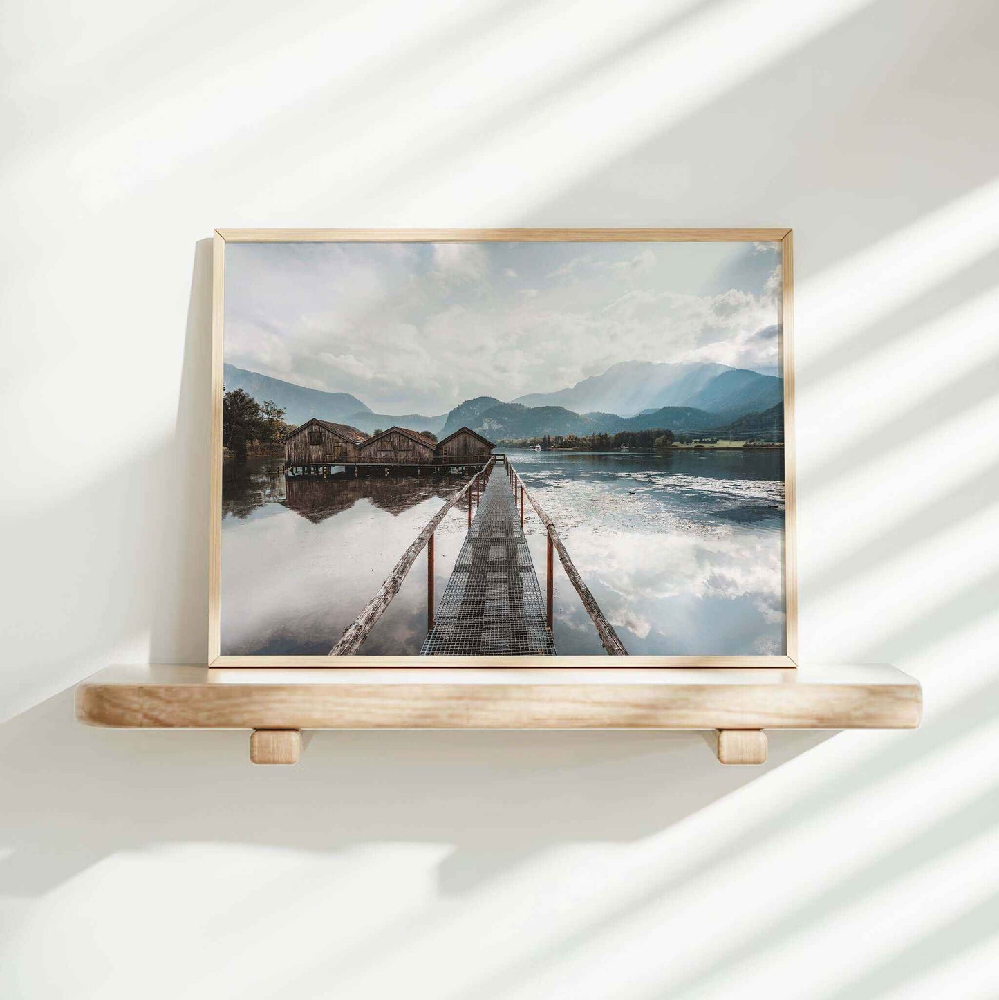 Woman decorating home with Kochelsee lake and boathouses landscape print