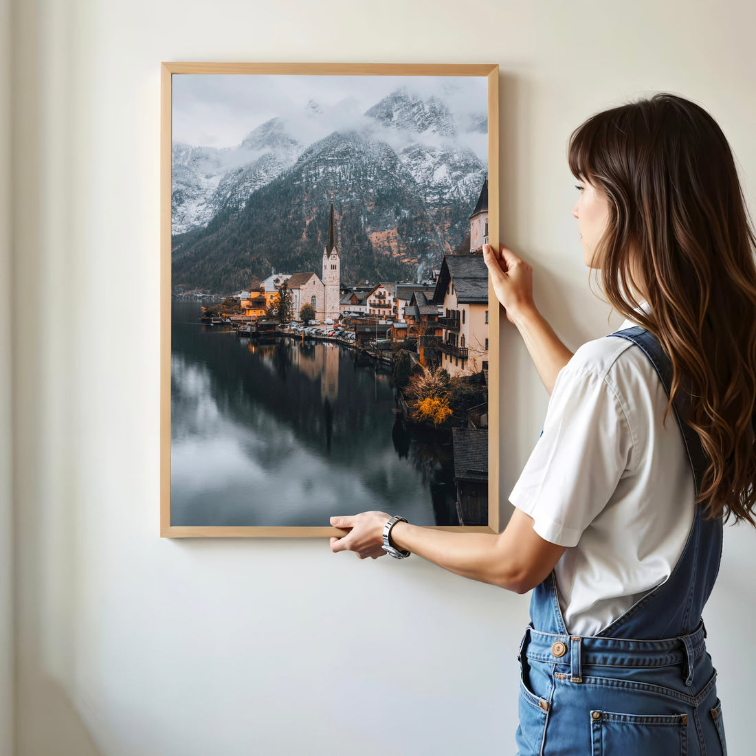 Woman hanging Hallstatt photo print on wall