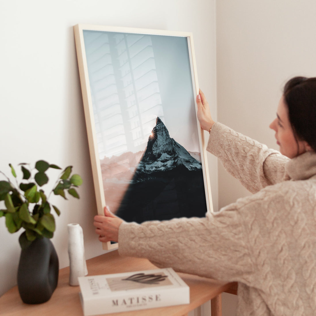 Woman styling a Matterhorn print with alpine glow and clean framing