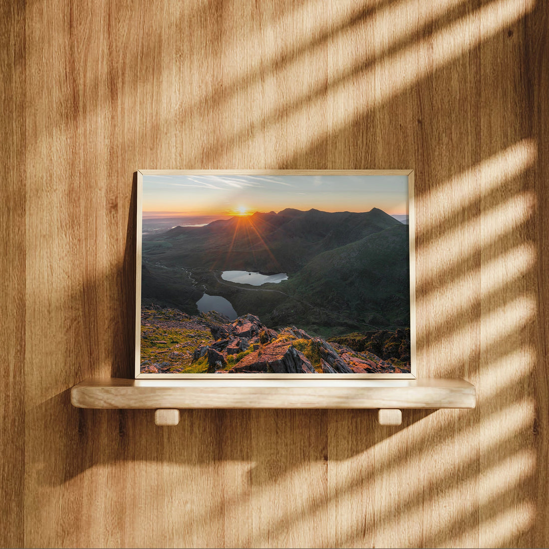 Carrauntoohil mountain sunrise photo displayed on a wood shelf.