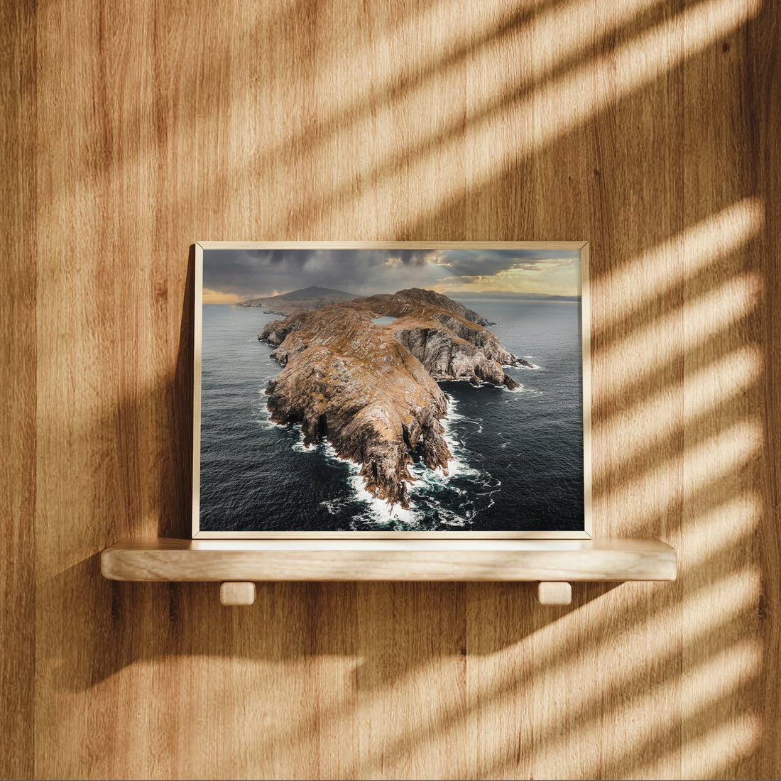 Irish coastal wall art print of Sheep’s Head displayed on a wooden shelf.