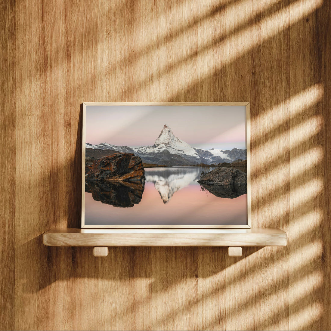Framed Matterhorn photography from Stellisee with glowing rocks and pastel sky in the Swiss Alps.