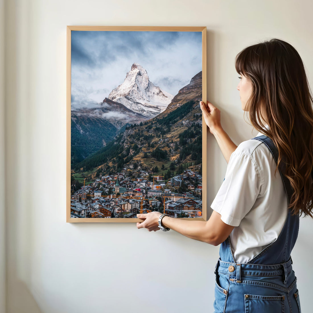 Framed Matterhorn poster being placed on a wall for home decor inspiration.